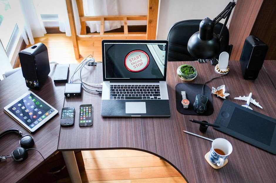 A contemporary office desk setup with laptops, gadgets, and accessories, creating a tech-savvy workplace